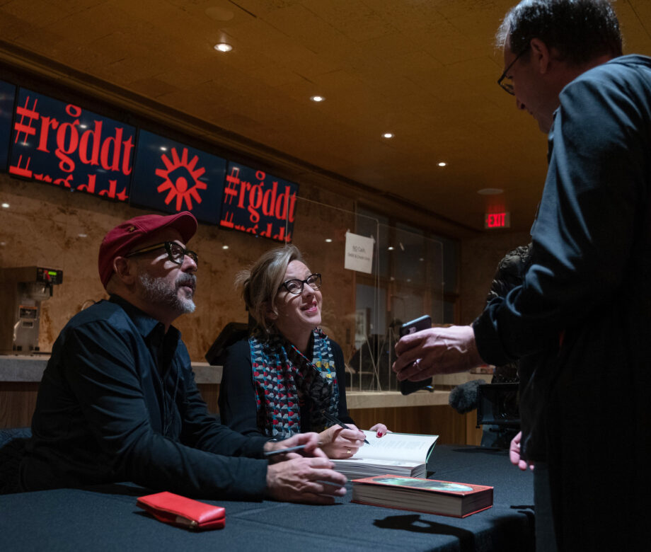 Designers from MinaLima signing their book.