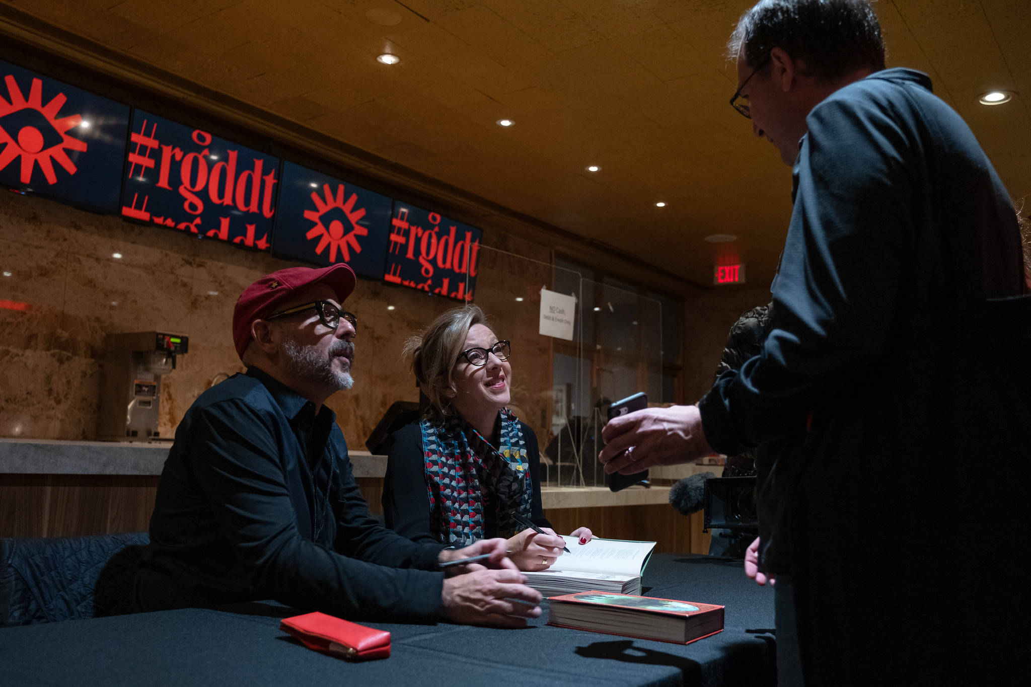 Designers from MinaLima signing their book.